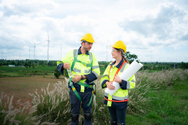 istock Engineer and worker discussing the project on the background of wind turbines 1577576010