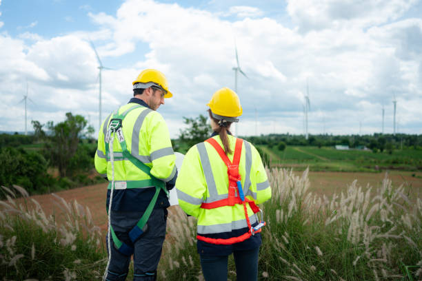 istock Engineer and worker discussing the project on the background of wind turbines 1577576016