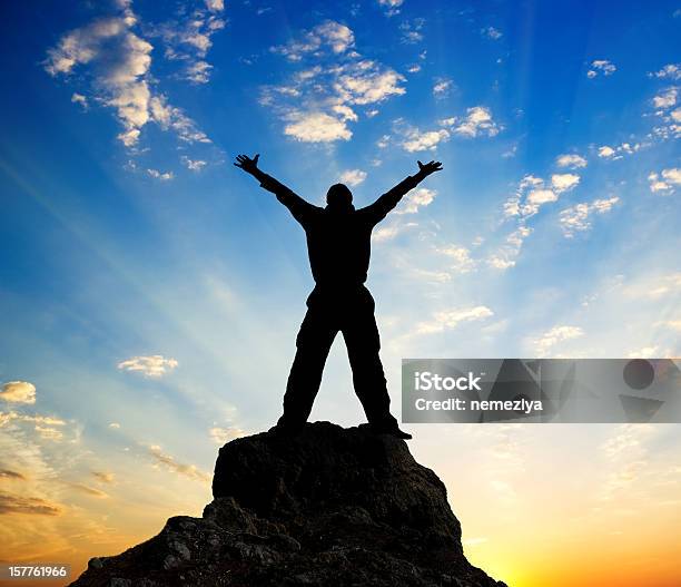 Silhouette Of A Man Standing On Top Of The Mountain Stock Photo - Download Image Now