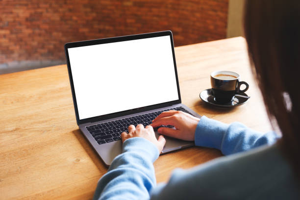 istock Mockup image of a woman using and typing on laptop computer with blank white desktop screen 1577645533