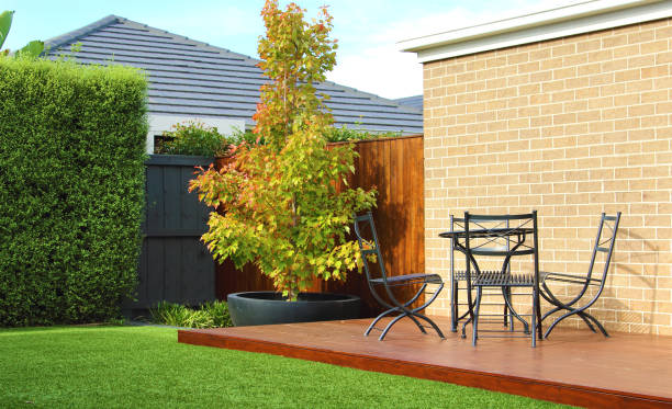 Typical Australian backyard features a lush artificial grass lawn, accompanied by a charming wooden decking area adorned with stylish outdoor furniture stock photo