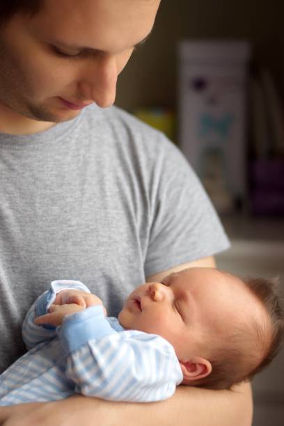 istock Father holding newborn baby boy 1577690655