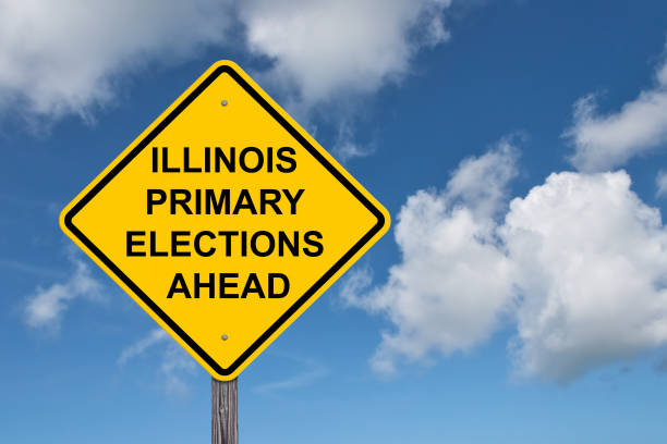 istock Illinois Primary Elections Ahead Caution Sign - Blue Sky Background 1577690837