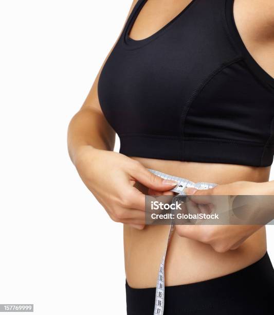 Slim Young Woman Measuring Her Waist Stock Photo - Download Image Now - 20-29 Years, Abdomen, Activity