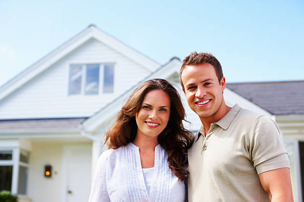 istock An attractive middle aged couple standing in front of house 157770030
