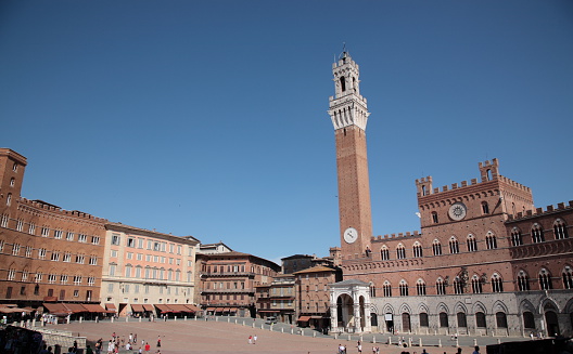 Mangia Tower at Piazza del Campo. Piazza del Campo is the principal public space of Siena, Tuscany, Italy and is one of Europe's greatest medieval squares.