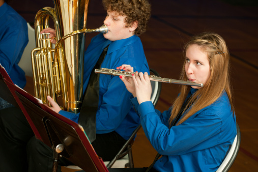 A highschool band playing in the gym