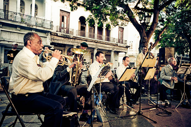 Details of musicians playing horn instrument in orchestra