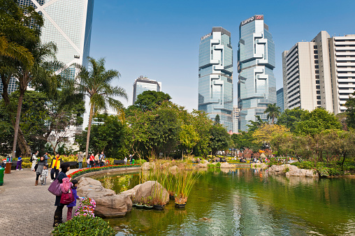 views of a city park in the middle of a beautiful lake or river and the activities of local residents and the continuity of animals and blooming flowers