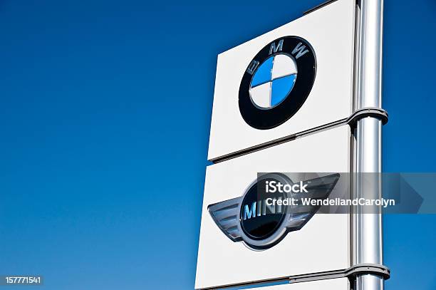 Bmw And Mini Cooper Sign Against Sky Stock Photo - Download Image Now - BMW, White Color, Blue