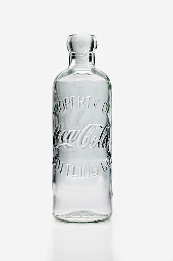 Open glass bottle, decanter with pattern. Isolated on a white background