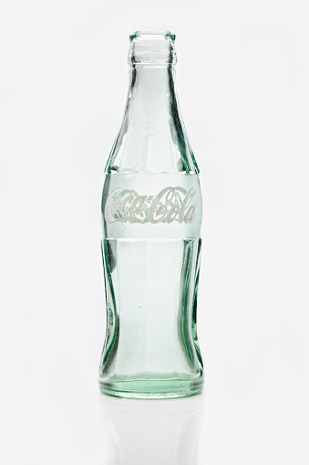 Florida, USA - Aug, 11, 2010: Coca Cola Contour Bottle with white applied color labeling (ACL), empty. Production started from year 1970 and it is part of the Coca Cola heritage bottle collection.