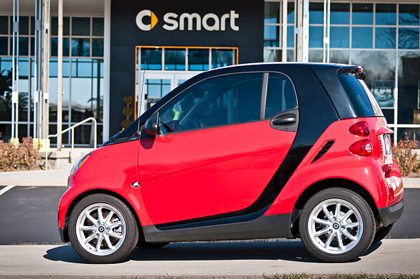 Smart Car In Front of Dealership Sign stock photo