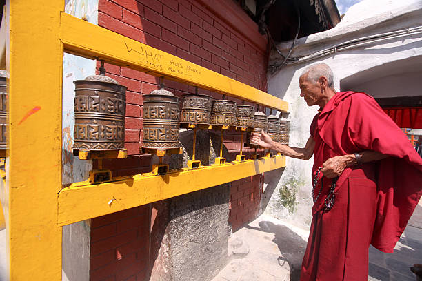 Buddhist monk in Kathmandu, Nepal  prayer wheel nepal kathmandu buddhism stock pictures, royalty-free photos & images