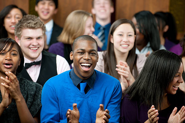 Church A diverse group of young adults at church - Buy credits sing praise stock pictures, royalty-free photos & images