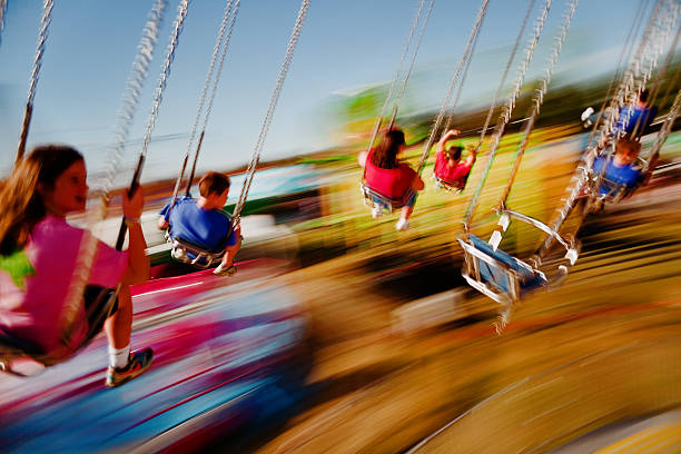 Speeding carousel fun at the fair stock photo