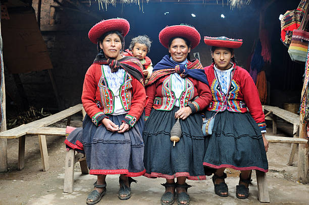 Chinchero indigenous woman selling products to tourist on a market, in Chinchero District