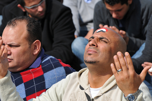 An Egyptian Muslim participates in Friday prayers during a time of protest in Cairo's Tahrir Square (February 11, 2011)