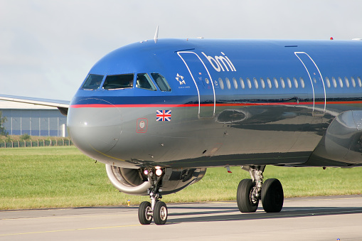 Portland, Oregon, USA - March 15, 2024: A Delta Airbus A319 landing at PDX in bright evening sunlight.