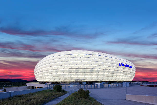 Dawn over illuminated soccer stadium Allianz Arena in Munich  allianz arena stock pictures, royalty-free photos & images