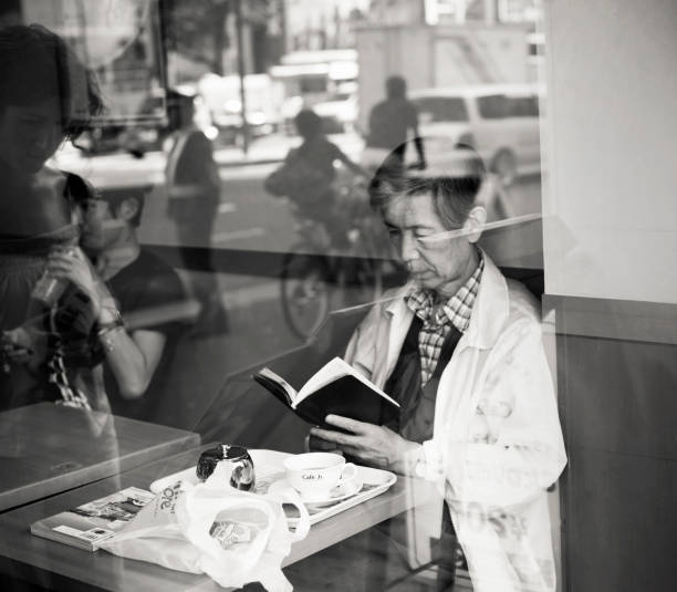 Hand Pointing and Reading a Book in Black and White