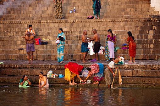Hindu devotees perform the 'Tarpan' rituals standing on water during Mahalaya prayers, also known as Pitru Paksha, in the banks of Brahmaputra river on October 14, 2023 in Guwahati, Assam, India.  Mahalaya is a day to honor their ancestors and seek their blessings.