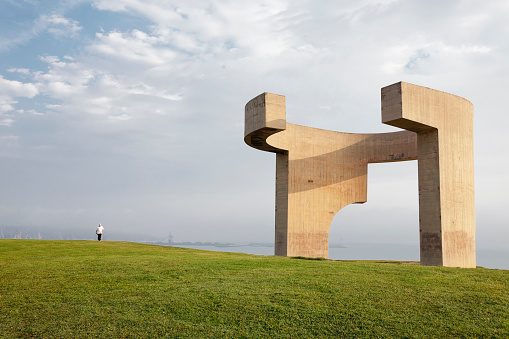 Gijón, Spain - June 25, 2010: Elogio del Horizonte, Eduardo Chillida sculpture donated to the city of Gijón, Spain. Located in the Cerro de Santa Catalina and has a height of 10 meters and 500 tons prey.