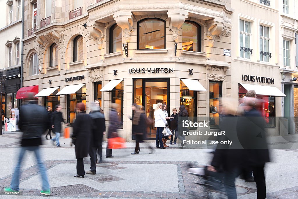 People Passing by a Louis Vuitton Store  Luxembourg City - Luxembourg Stock Photo