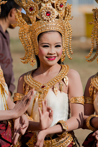 Surin, Thailand- November 20, 2010: Thai female makes Traditional Dance pose while dressed in traditional costume with elaborate gold headdress. 

The dance performance is part of the annual 