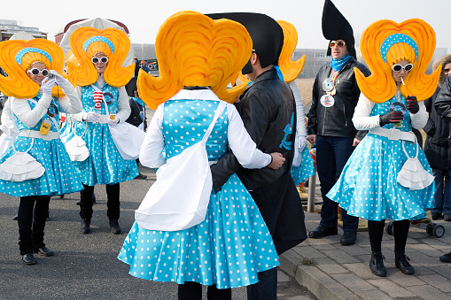 Cologne, Germany - February 11, 2024: On Carnival Sunday in Cologne, there are the traditional parades of schools and societies, Schull- un Veedelszöch the participants are usually wearing self made costumes,  here a marching band wearing colorful costumes