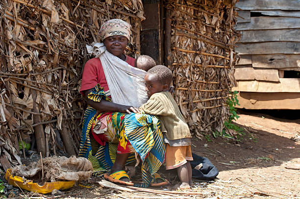 Pygmy woman and her children in front of their hut  lake kivu stock pictures, royalty-free photos & images