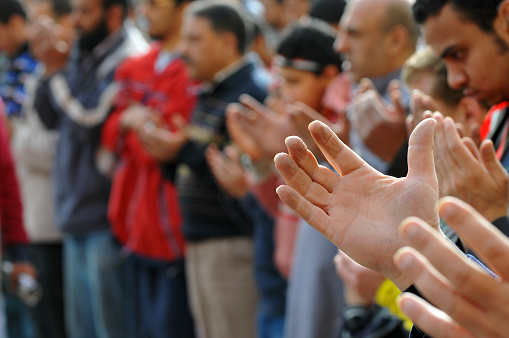 Muslim men pray with lifted hands in Tahrir Square in Cairo, Egypt, during mass protest against the regime of President Hosni Mubarak. (Februay 11, 2011)