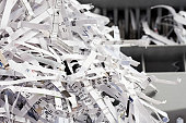 Pile of Shredded Paper with Shredder in Background