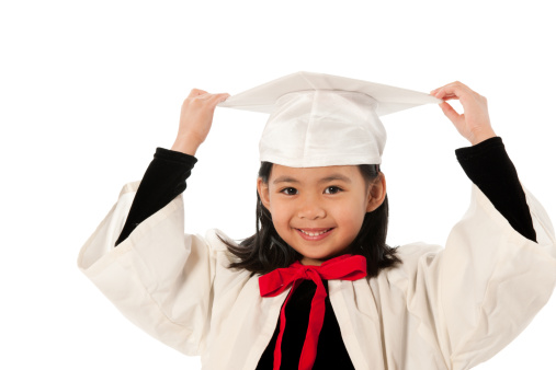 A young girl wearing a graduation outfit. - Buy credits