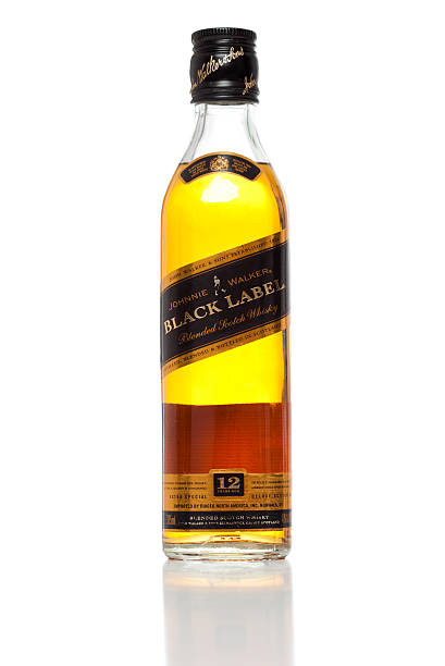 bottle of whiskey on gray background - isolated - closeup