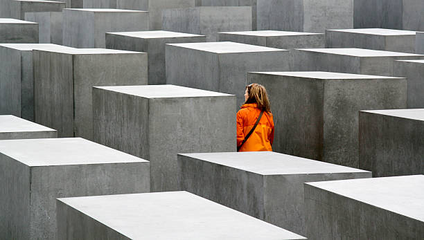 Young woman visiting the Holocaust Memorial in Berlin, Germany stock photo
