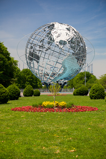A large hologram of the planet earth as a background with grass out of focus