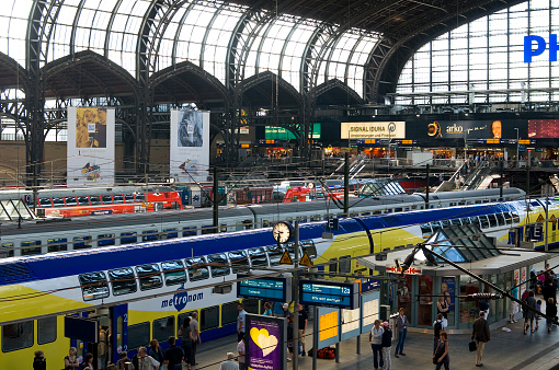 Birmingham, UK - Passengers inside the spacious interior of Birmingham's New Street train station, with several retail and restaurant options available.