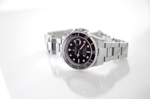 a noble diving watch with metal bracelet and black dial