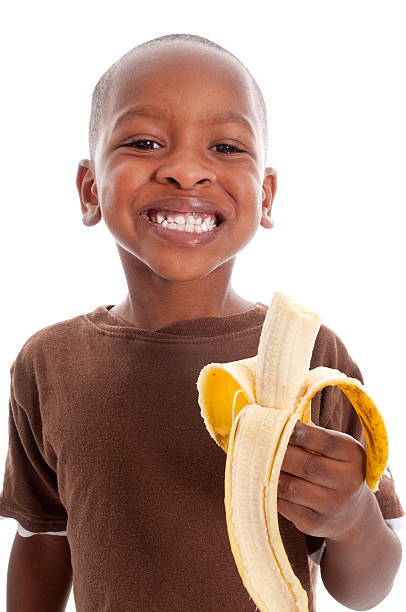 Little Boy eating a banana stock photo