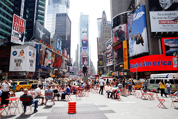 NEW YORK, USA - MARCH 23: Unknown people on Times Square. Times Square is a major commercial intersection and a neighborhood in Midtown Manhattan on March 23, 2014 in New York, USA