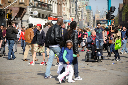 People shopping in the streets of Zwolle during the annual Blauwvingerdagen market fair held every year on wednesdays in July. People are looking at the market stalls and enjoying food and drinks at the outdoor bar seatings.