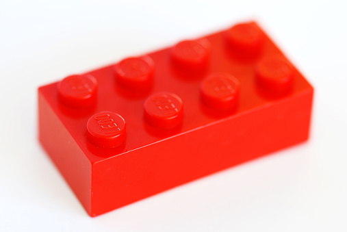 Pila, Italy - April 9, 2011: An old red Lego brick from the 80s isolated on white. LEGO are famous construction toys manufactured by the Lego Group, a company based in Billund, Denmark.