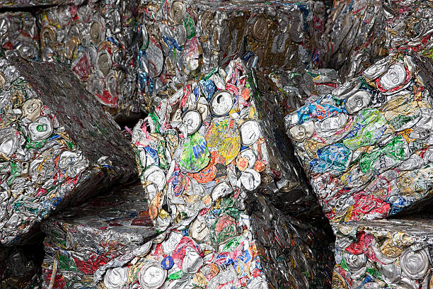 Rayong, Thailand- September 18, 2008:  Used aluminum soda and beer cans compressed into a solid metal square, ready for recycling. These blocks of aluminum for recycling are then melted down in a furnace, where impurities are burned off.