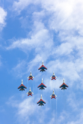 Russian Air Force planes paint the colors of the Russian flag in the sky on St. Petersburg during the celebration of the Day of the Navy