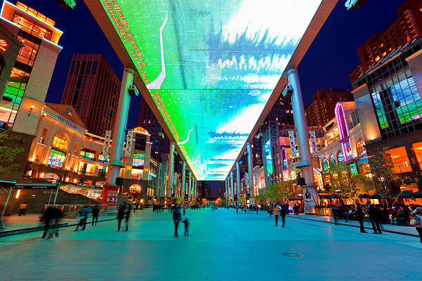 Beijing, China - April 10, 2011: Crowd looking at the movie show on the world's largest LCD screen (30m x 250m) at \
