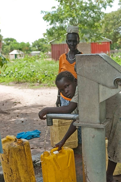 Pumping Water in South Sudan, Africa.  south sudan stock pictures, royalty-free photos & images