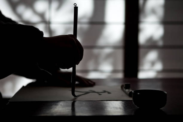 Mature man writing a calligraphic type stock photo