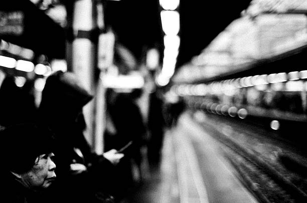 Shot of unrecognizable people walking on subway station superimposed over Wall Street cityscape, Lower Manhattan, NYC.