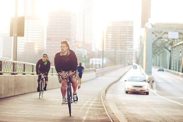 Low angle view of defocused unrecognizable man exercising on his mountain bicycle in a bicycle lane. Toned image. XXXL 42Mp studio photo taken with SONY A7rII and Zeiss Batis 40mm F2.0 CF